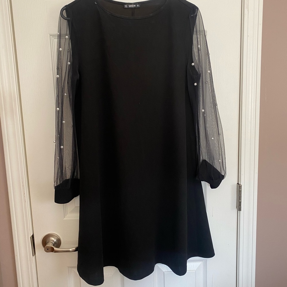 Black A-line dress with pearl detail on sleeve